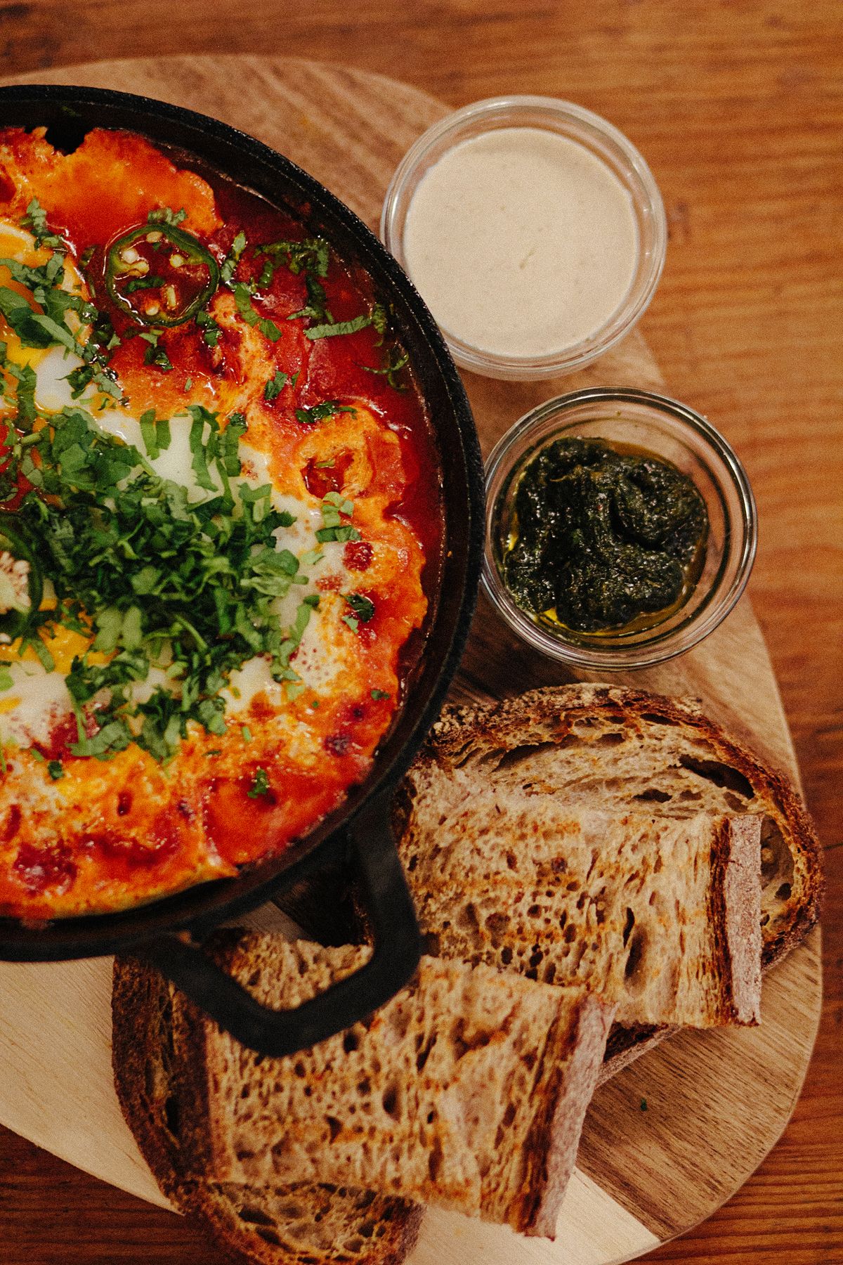 Shakshuka skillet with toasted bread at Morgans On The Danforth